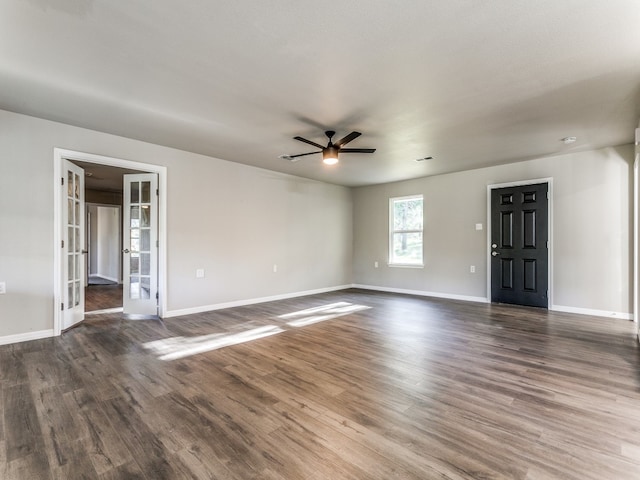 unfurnished room featuring ceiling fan, dark hardwood / wood-style floors, and french doors