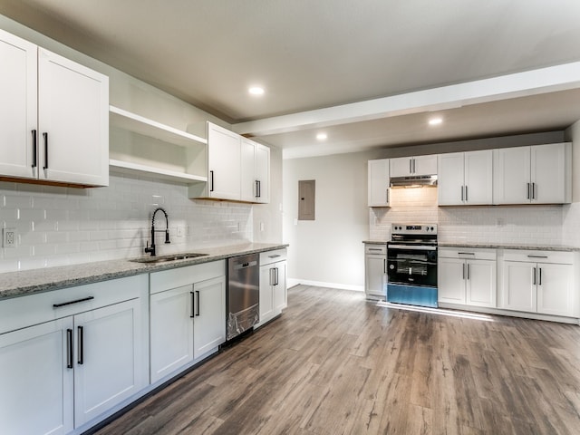 kitchen with appliances with stainless steel finishes, wood-type flooring, tasteful backsplash, and sink