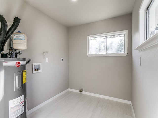 clothes washing area featuring hookup for an electric dryer, washer hookup, and electric water heater