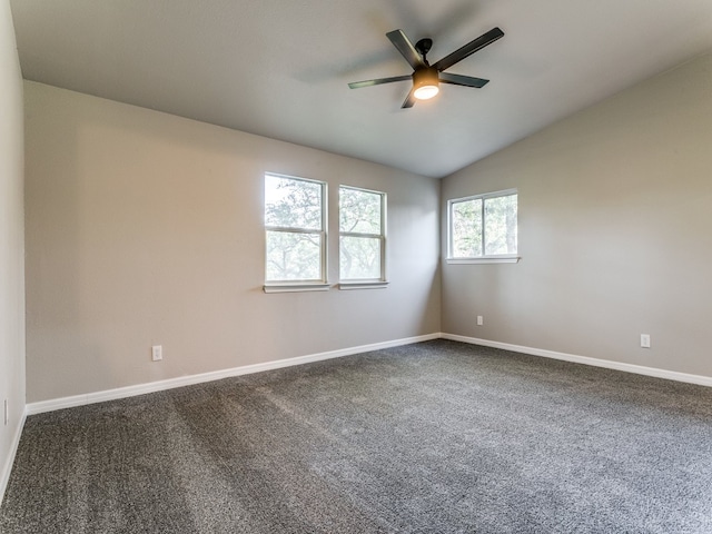 carpeted spare room with ceiling fan and vaulted ceiling