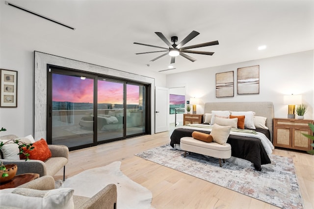 bedroom featuring access to outside, ceiling fan, and light hardwood / wood-style floors