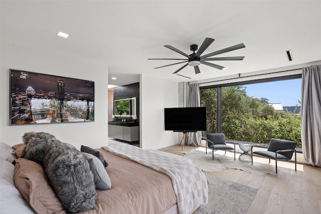 bedroom with ceiling fan and light hardwood / wood-style floors