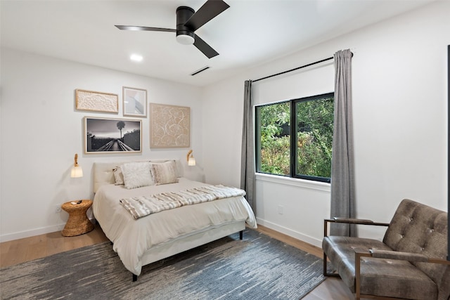 bedroom with hardwood / wood-style floors and ceiling fan