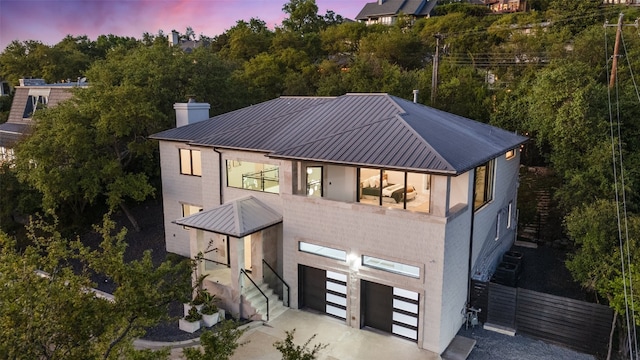 exterior space with a garage and a balcony