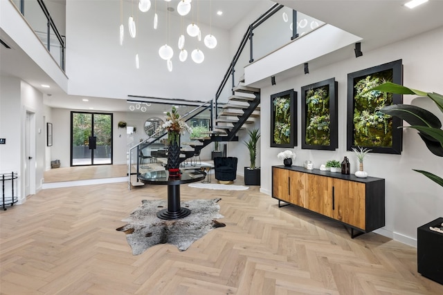 entryway with a high ceiling and light parquet flooring