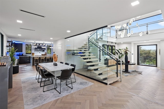 dining area featuring light parquet floors and a chandelier