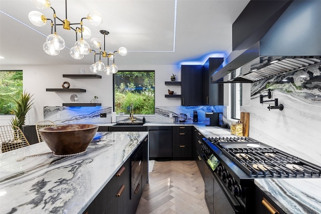 kitchen featuring dishwasher, black range with gas stovetop, light stone counters, ventilation hood, and backsplash