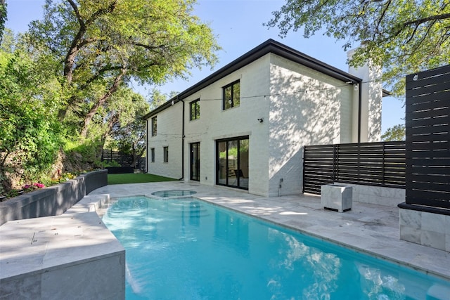 view of pool with an in ground hot tub