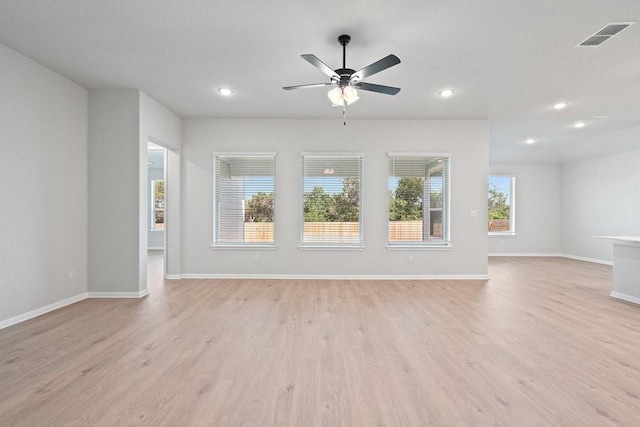 unfurnished living room with ceiling fan and light wood-type flooring