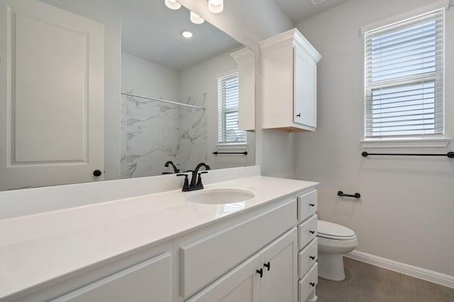 bathroom with vanity, tile patterned floors, walk in shower, and toilet