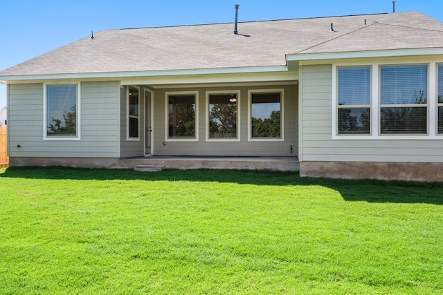 back of house featuring a yard