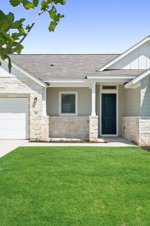 view of front of house with a garage and a front lawn