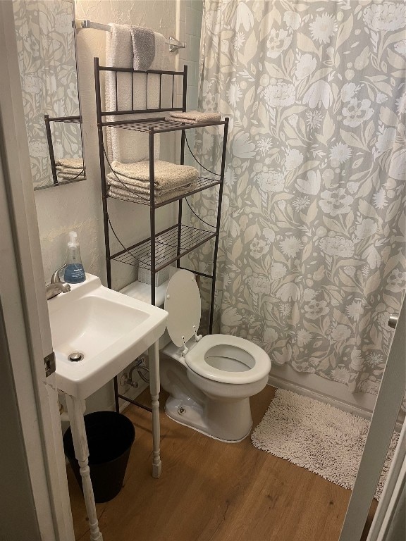 bathroom featuring toilet and hardwood / wood-style floors