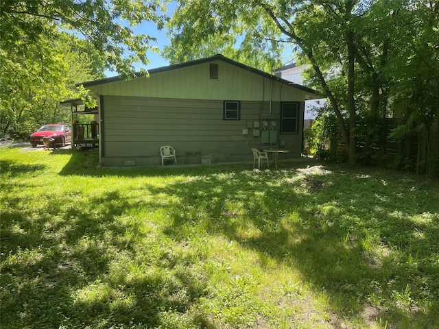 view of side of home featuring a yard