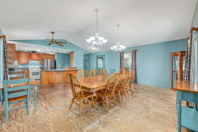 dining space featuring lofted ceiling and ceiling fan with notable chandelier