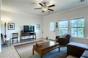 living room with crown molding and ceiling fan