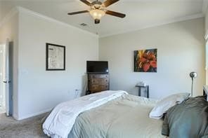 bedroom with ornamental molding, light colored carpet, and ceiling fan