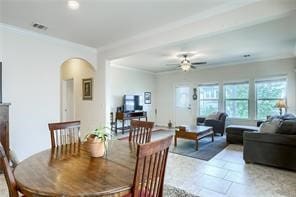 tiled dining room featuring ceiling fan and crown molding