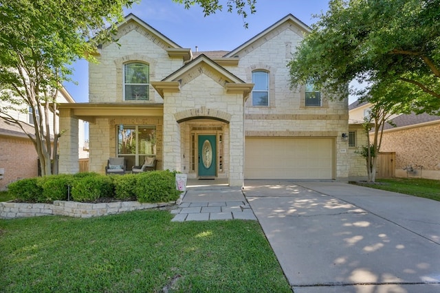 view of front of house with a porch, a garage, and a front yard