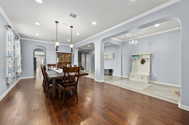 dining area featuring hardwood / wood-style flooring and crown molding