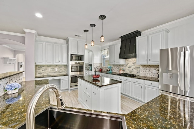 kitchen featuring stainless steel appliances, sink, dark stone countertops, and white cabinets