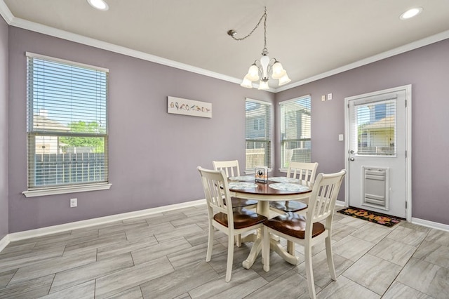 dining space featuring plenty of natural light, ornamental molding, and a chandelier