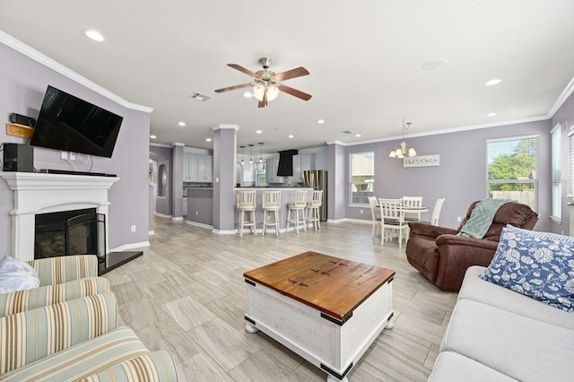 living room featuring crown molding and ceiling fan