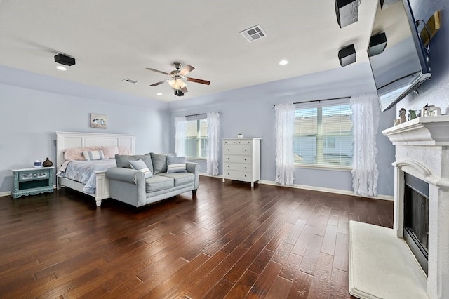 bedroom with ceiling fan, dark hardwood / wood-style floors, and multiple windows