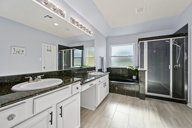 bathroom featuring vanity and separate shower and tub