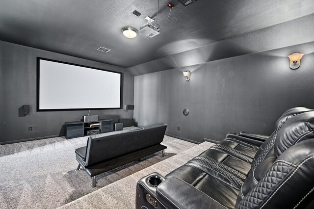 carpeted home theater featuring a textured ceiling