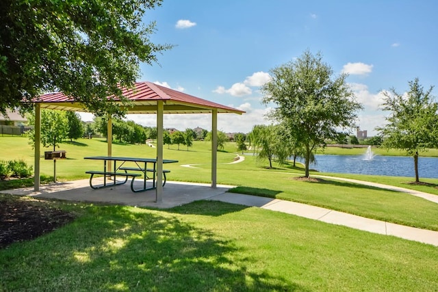 view of community with a gazebo, a water view, and a yard