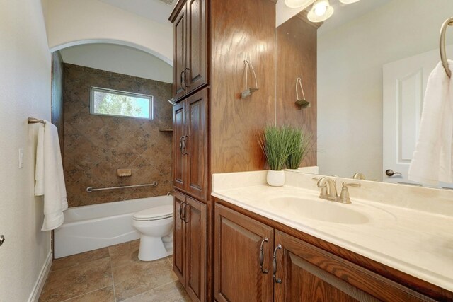 full bathroom with vanity, tiled shower / bath combo, and toilet