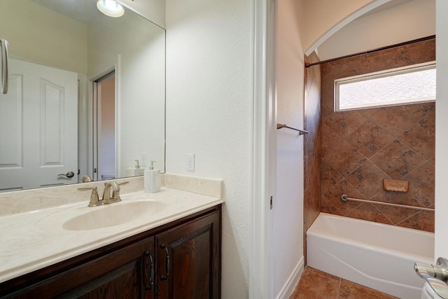 bathroom with tile patterned floors, vanity, and tiled shower / bath combo