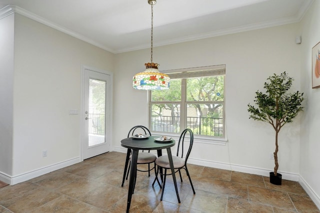 dining space featuring a wealth of natural light and crown molding