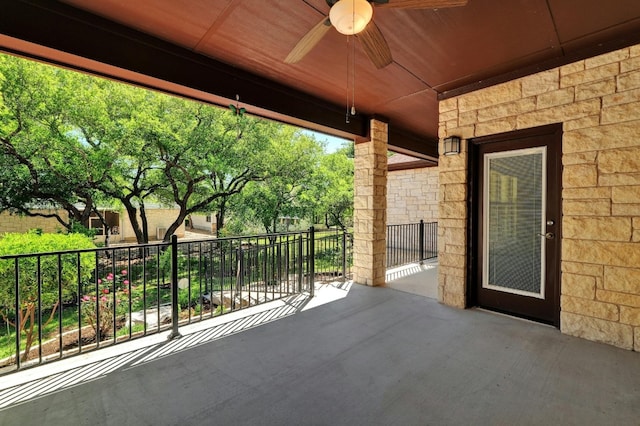 view of patio featuring ceiling fan and a balcony