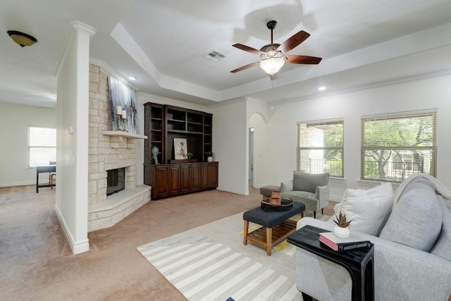 living room with ornamental molding, light carpet, and a wealth of natural light