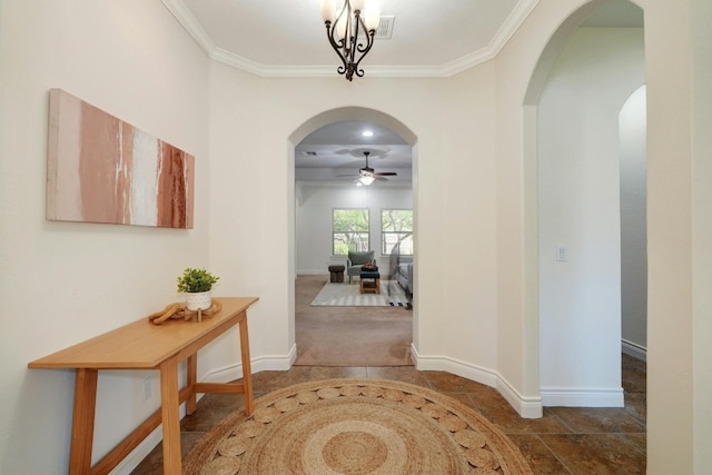 corridor featuring crown molding and a notable chandelier