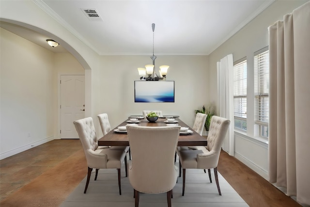 dining area with crown molding and a notable chandelier