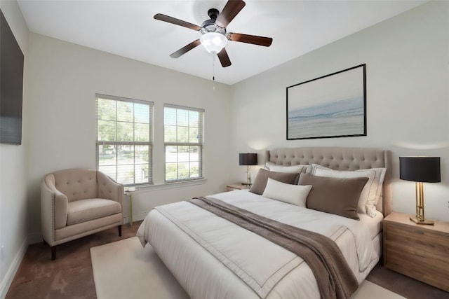 bedroom featuring ceiling fan and dark carpet