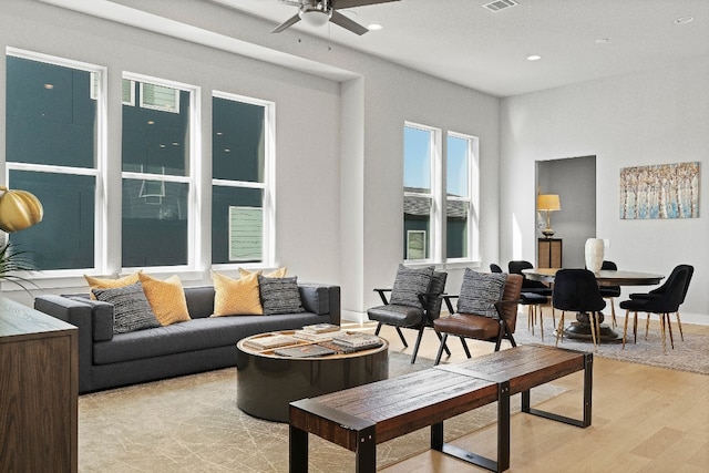 living room with ceiling fan and light wood-type flooring