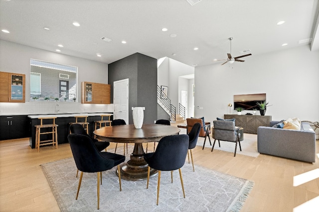 dining area with light hardwood / wood-style flooring and ceiling fan