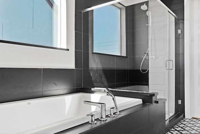 bathroom featuring tile walls, separate shower and tub, and tile floors