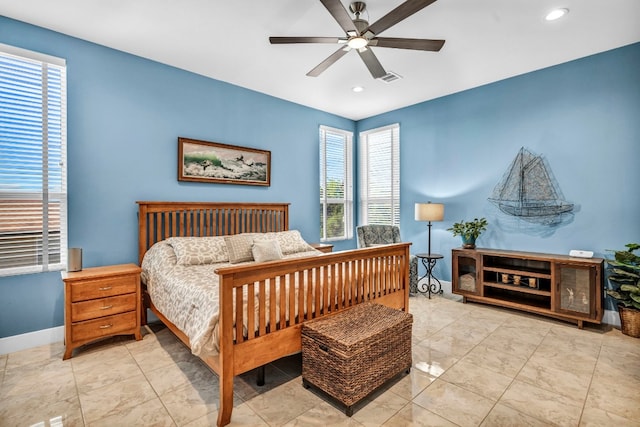 tiled bedroom featuring ceiling fan