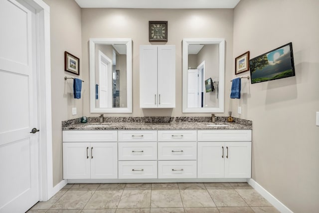 bathroom featuring dual bowl vanity and tile flooring