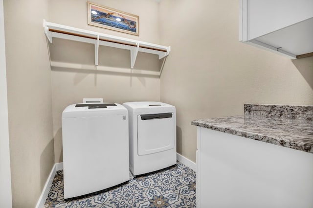 laundry area with light tile floors and washing machine and clothes dryer