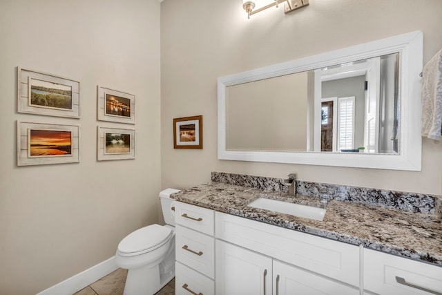 bathroom featuring toilet, tile flooring, and large vanity