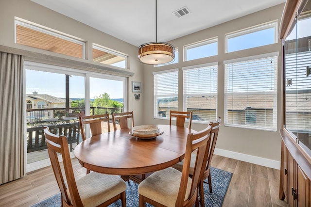 dining room featuring light hardwood / wood-style flooring and a healthy amount of sunlight