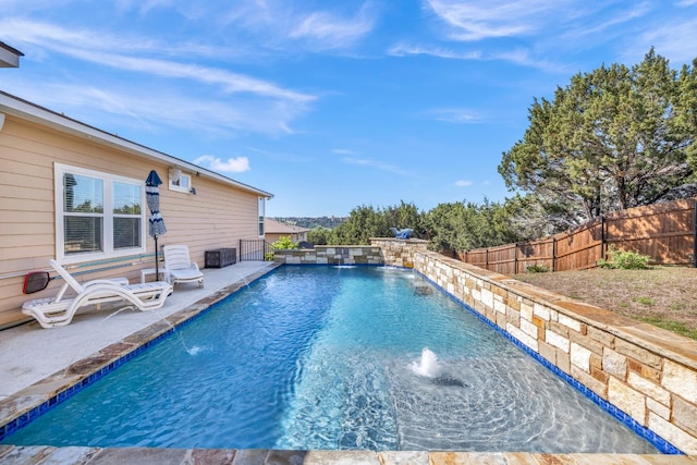 view of pool with a patio area and pool water feature