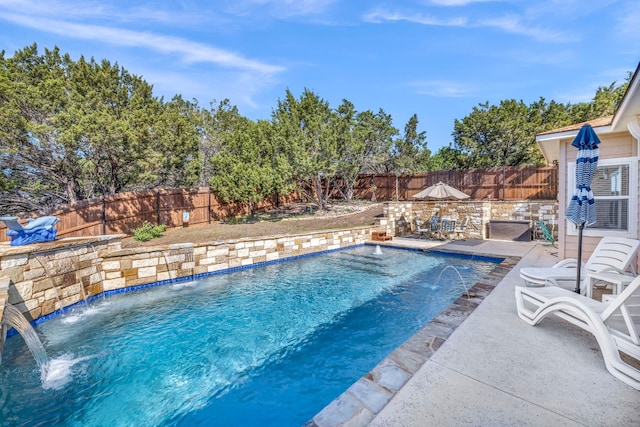 view of pool with a patio area and pool water feature