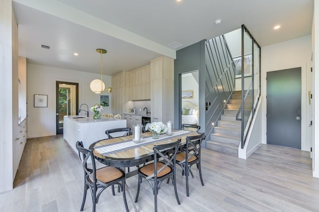 dining area featuring light hardwood / wood-style floors and sink